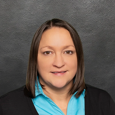 Chiropractor Amanda Pennekamp Smiling In Light Blue Shirt
